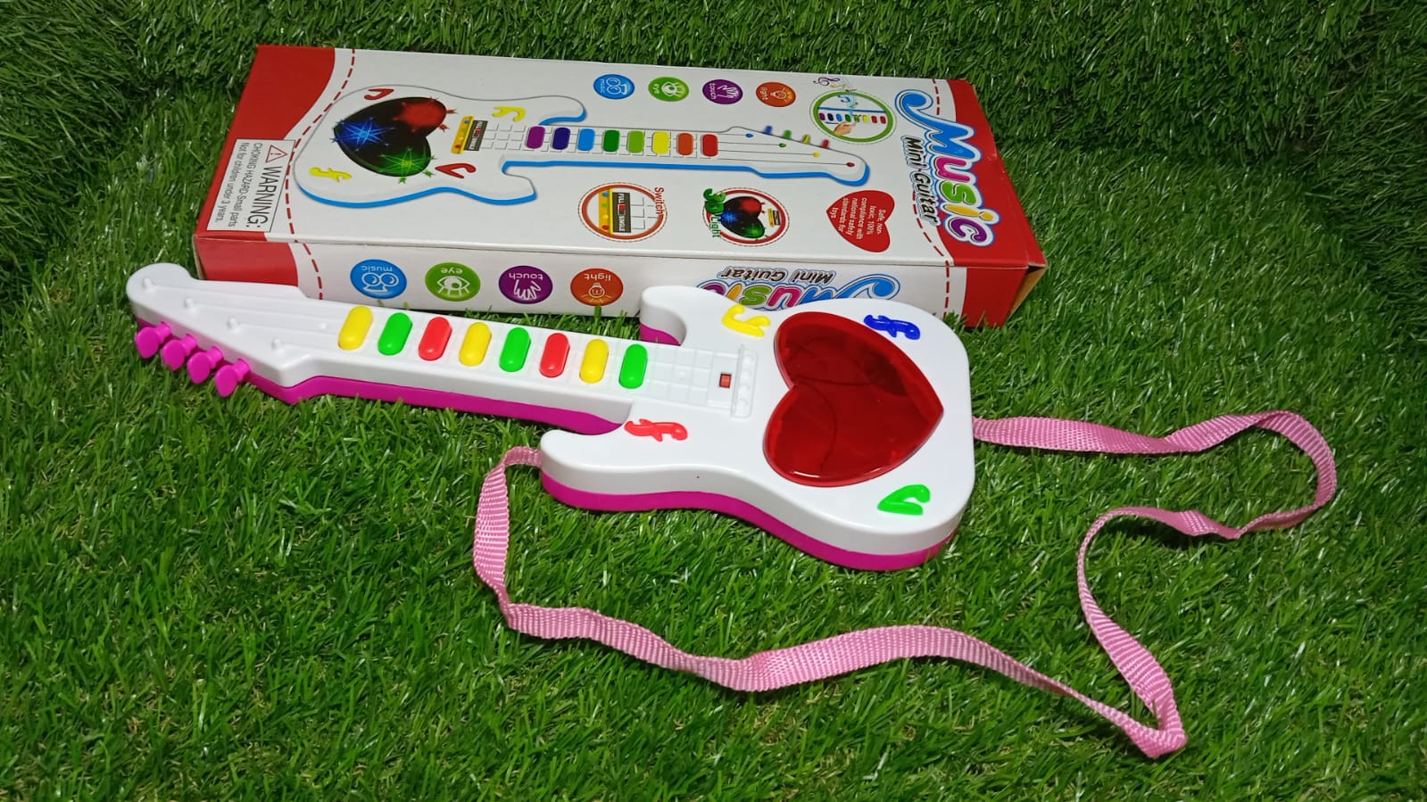 Fun mini guitar toy with lights and music. Fun mini guitar toy with lights and music.